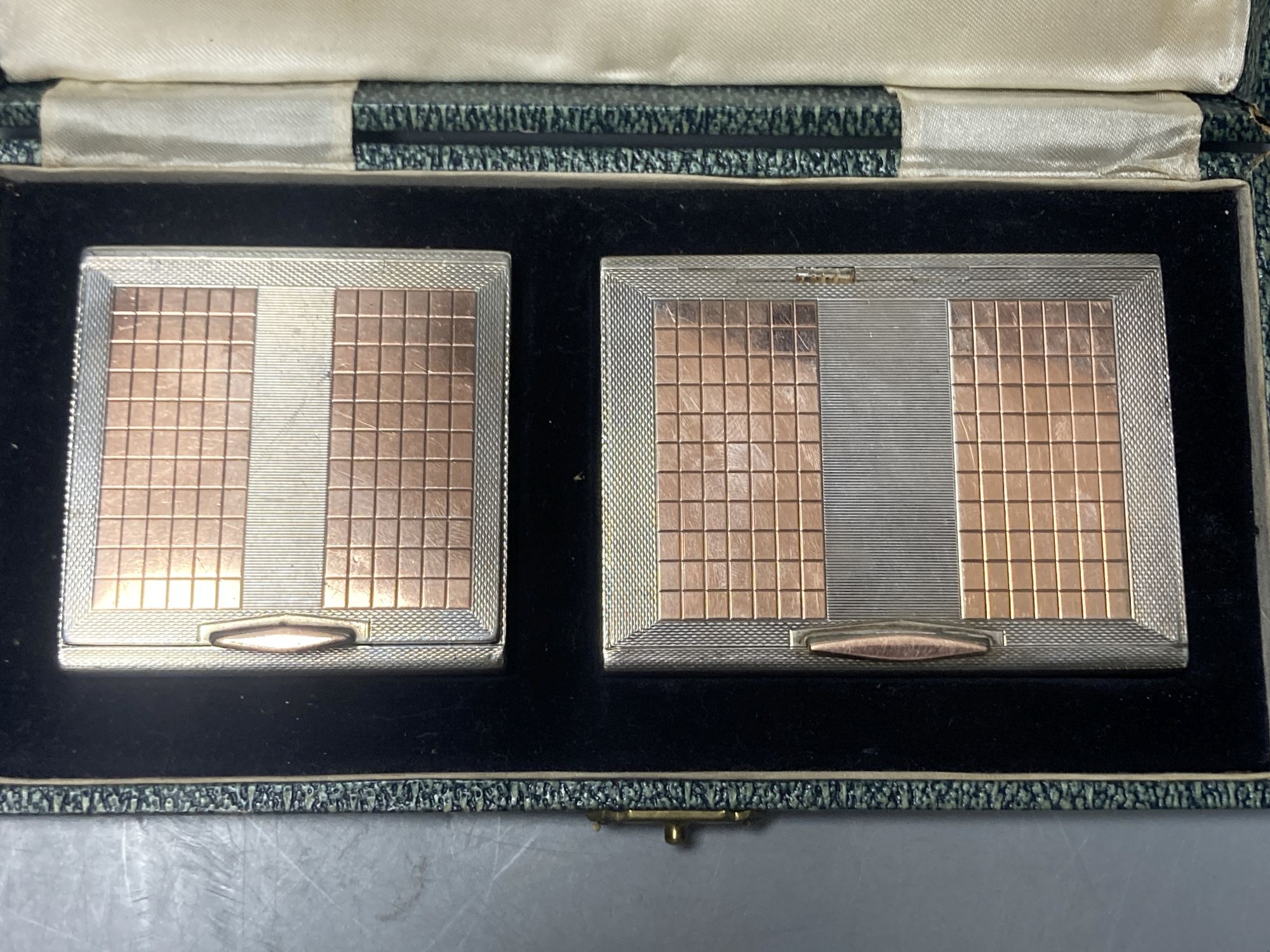 An early 1950s cased engine turned silver and yellow metal cigarette case and matching compact,